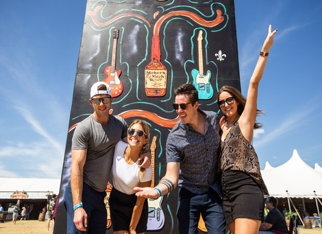 Description: A group of people posing for a photo in front of a signDescription automatically generated with medium confidence