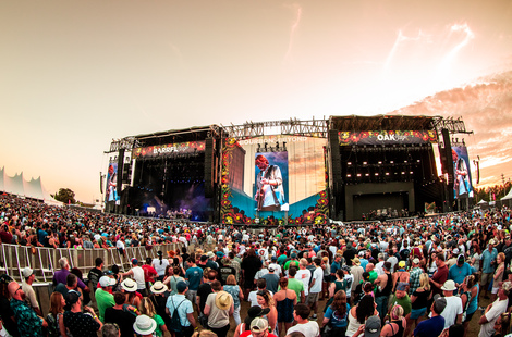 Description: A large crowd of people in front of a stageDescription automatically generated